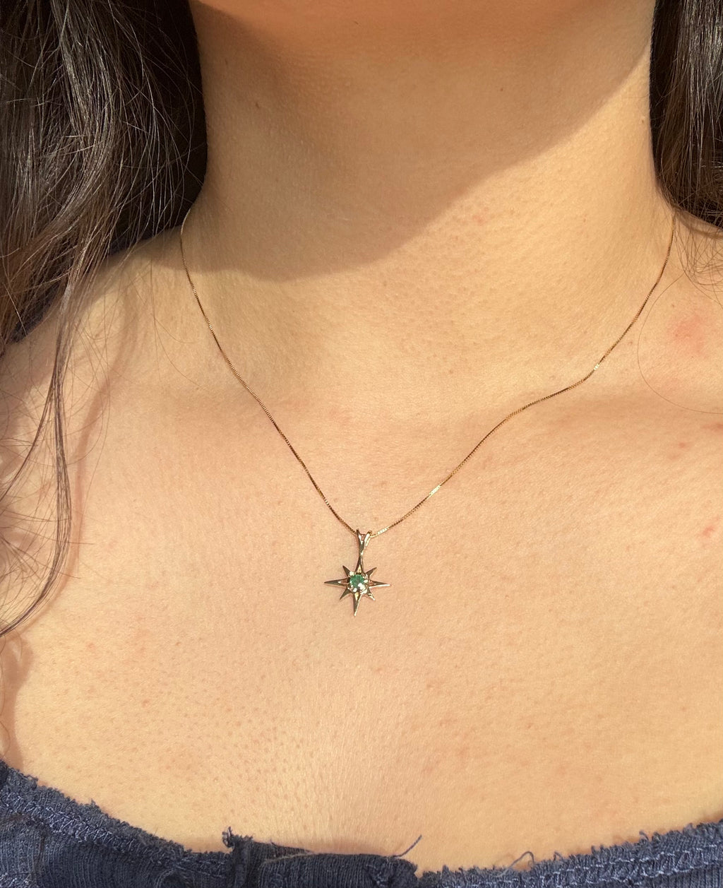 14k solid gold emerald star pendant necklace on box chain worn on neck showing length and placement