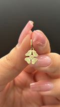 14k solid gold four-leaf clover charm close-up showing detail and condition