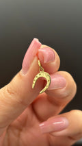 18k solid gold horseshoe charm close-up showing surface condition and detail