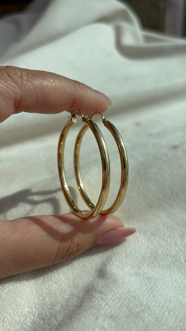 14k Solid Gold X-Large Tube Hoops close-up showing smooth high polish finish