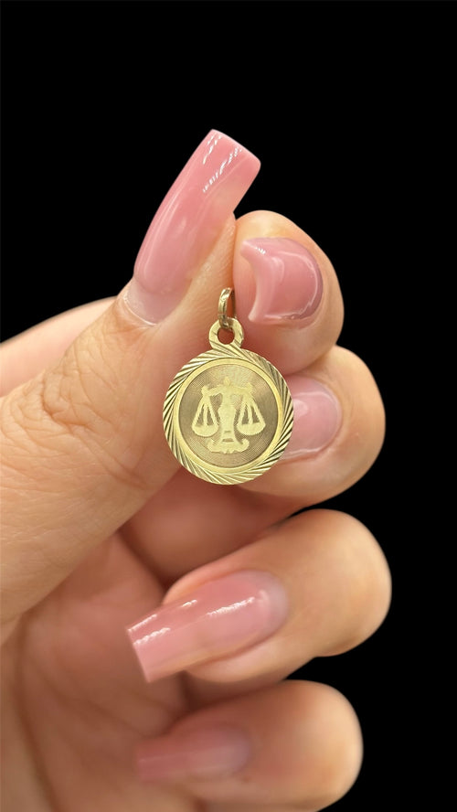 Front of 10k engine turned border Libra charm