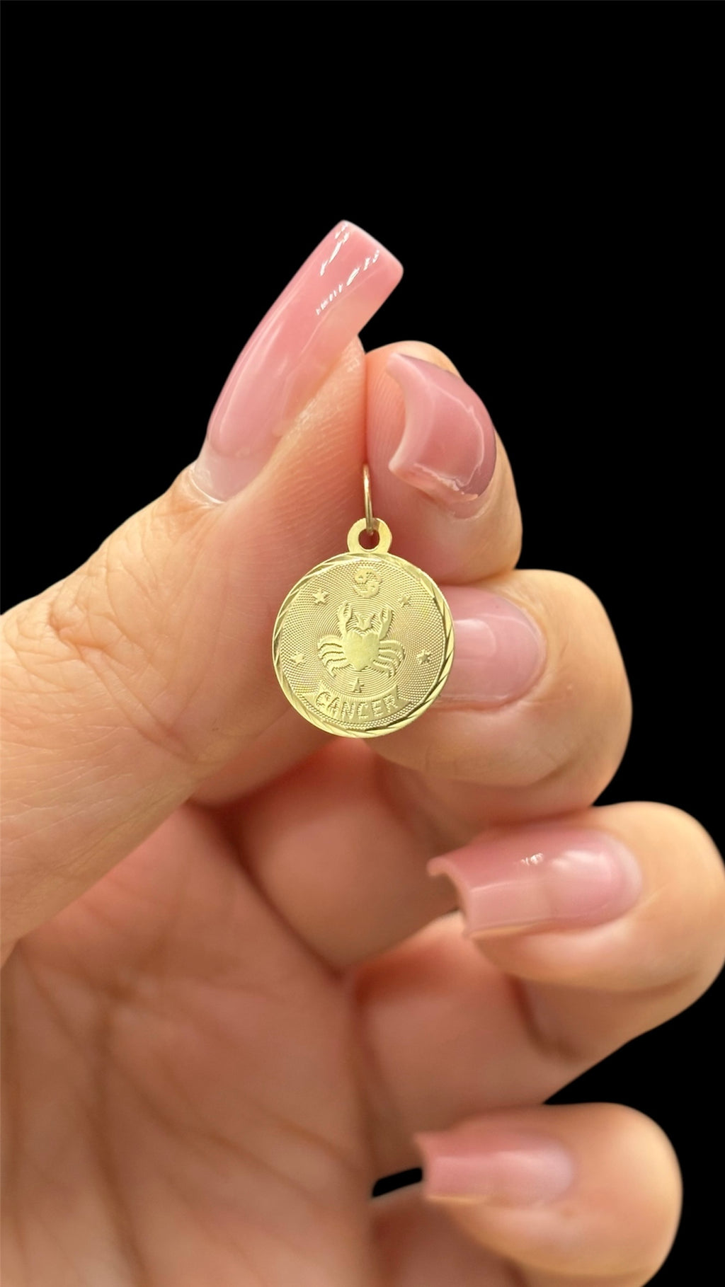 Front of 14k solid gold circular Cancer charm