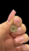 Front of 10k solid gold Pisces charm with scalloped edge