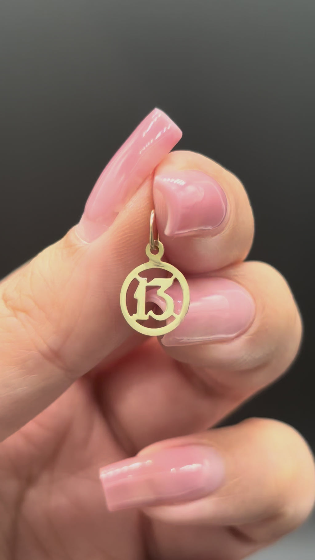 10k solid gold mini 13 charm close-up video showing gold shine and reflection