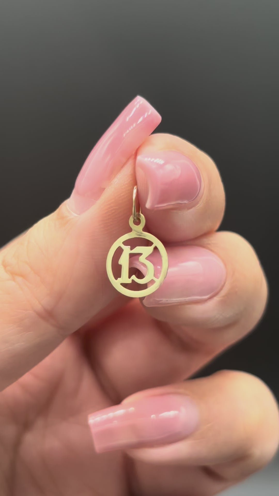 10k solid gold mini 13 charm close-up video showing gold shine and reflection