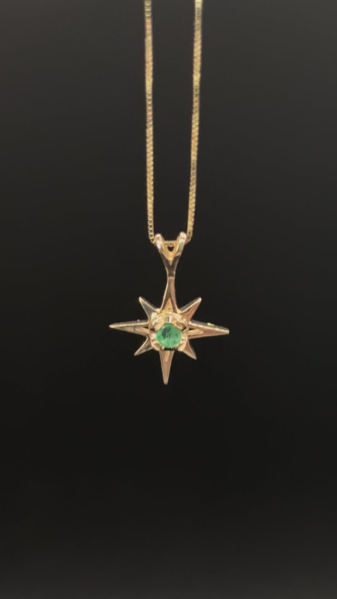 14k solid gold emerald star pendant necklace close-up on box chain showing stone and setting detail